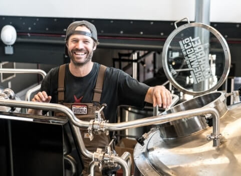 man smiling while working at brewery